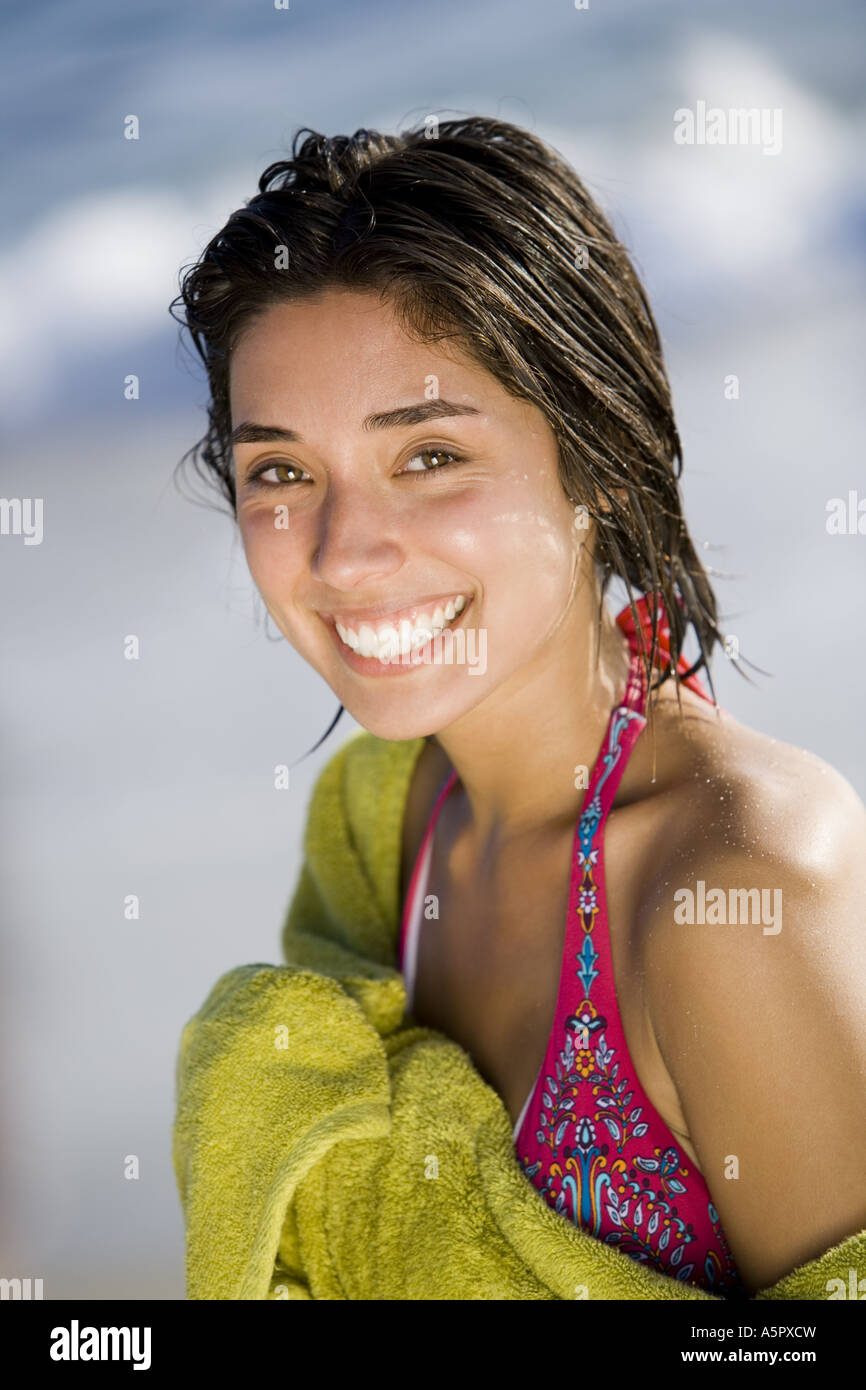 Woman on beach wrapped in a towel Stock Photo Alamy