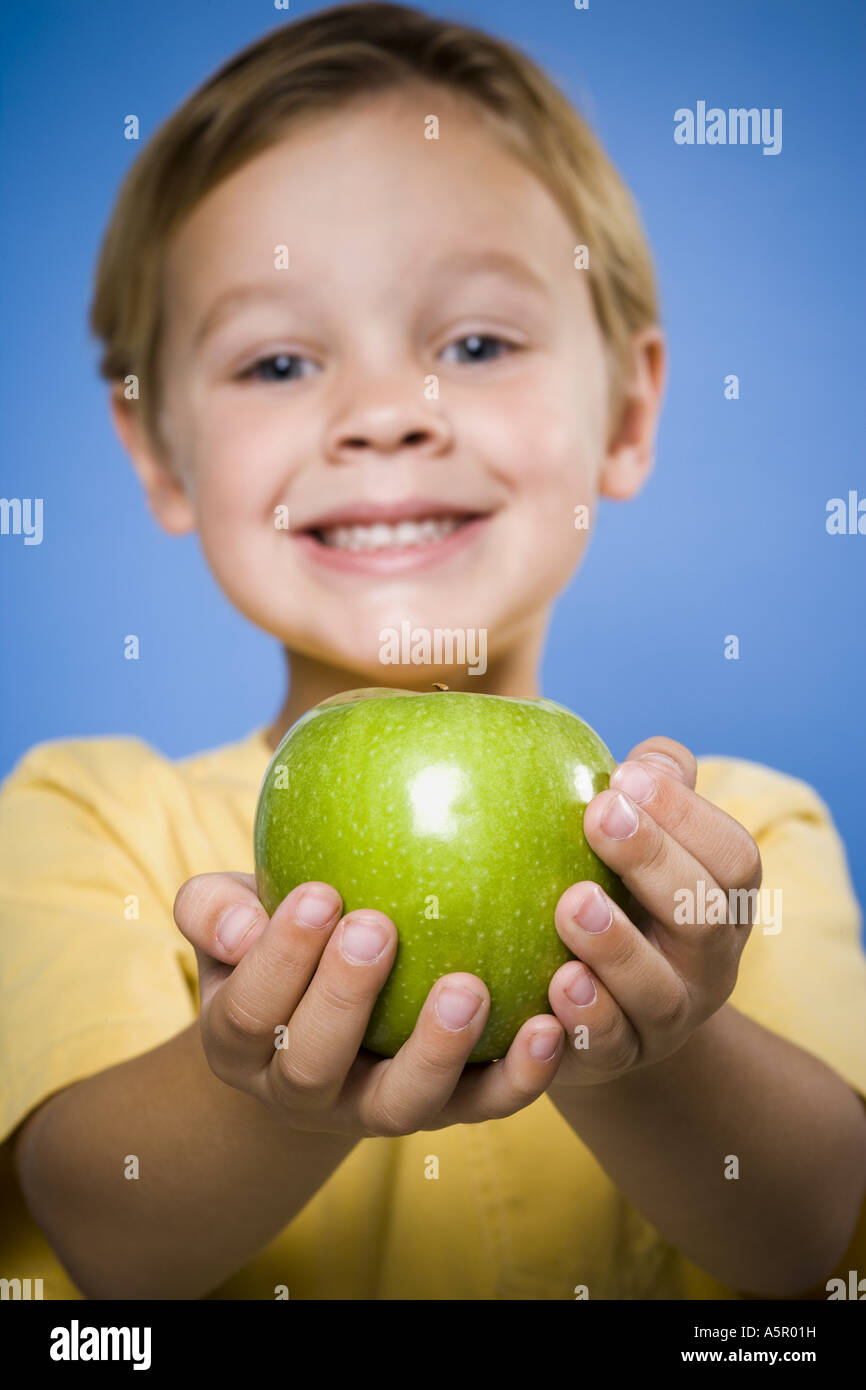 Boy with green apple smiling Stock Photo Alamy