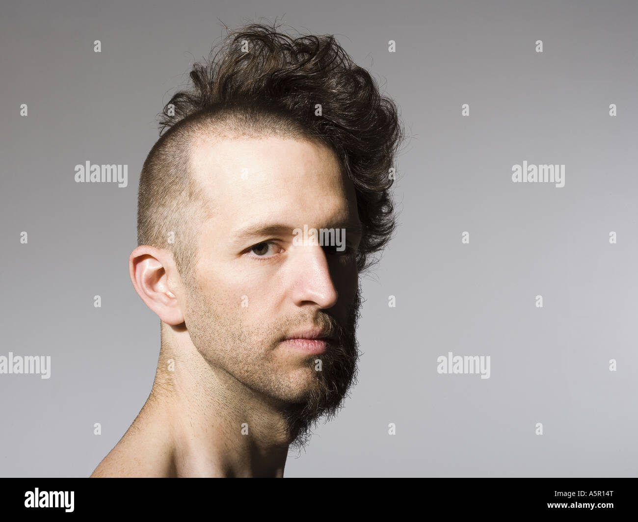 Shirtless Man With Half Shaved Hair And Beard Stock Photo