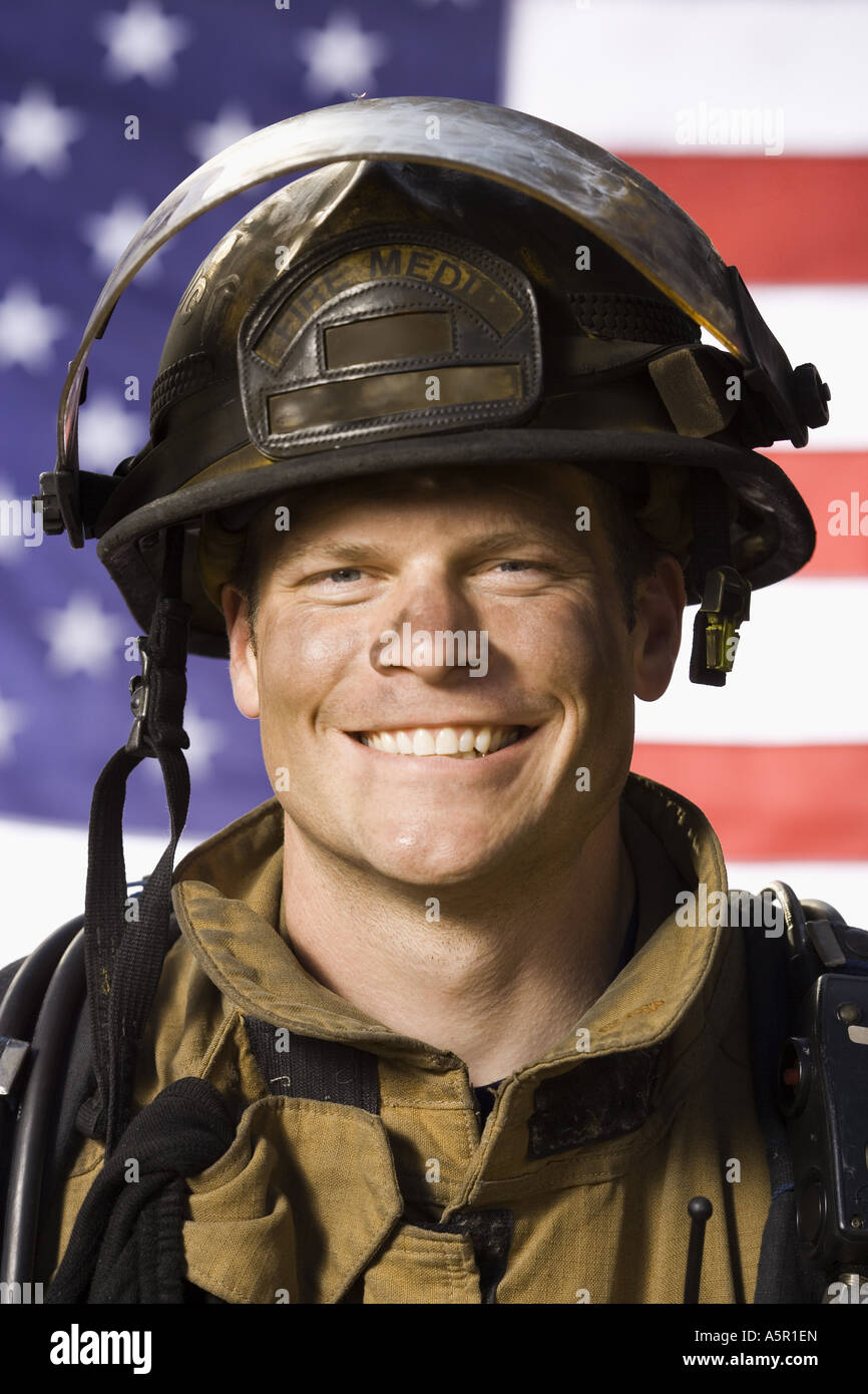 Portrait of a firefighter smiling with US flag Stock Photo - Alamy