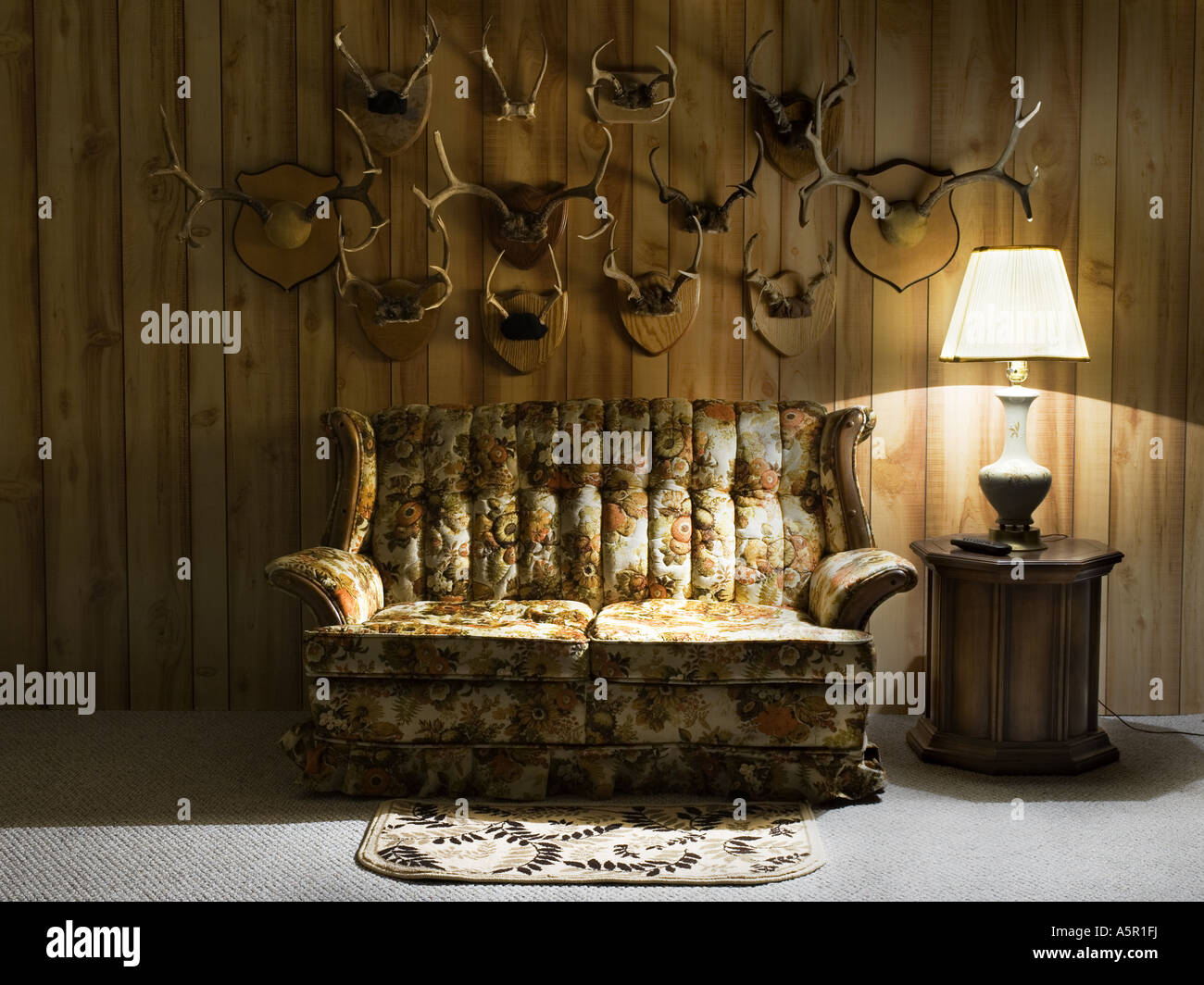 Sofa with lamp and antlers Stock Photo