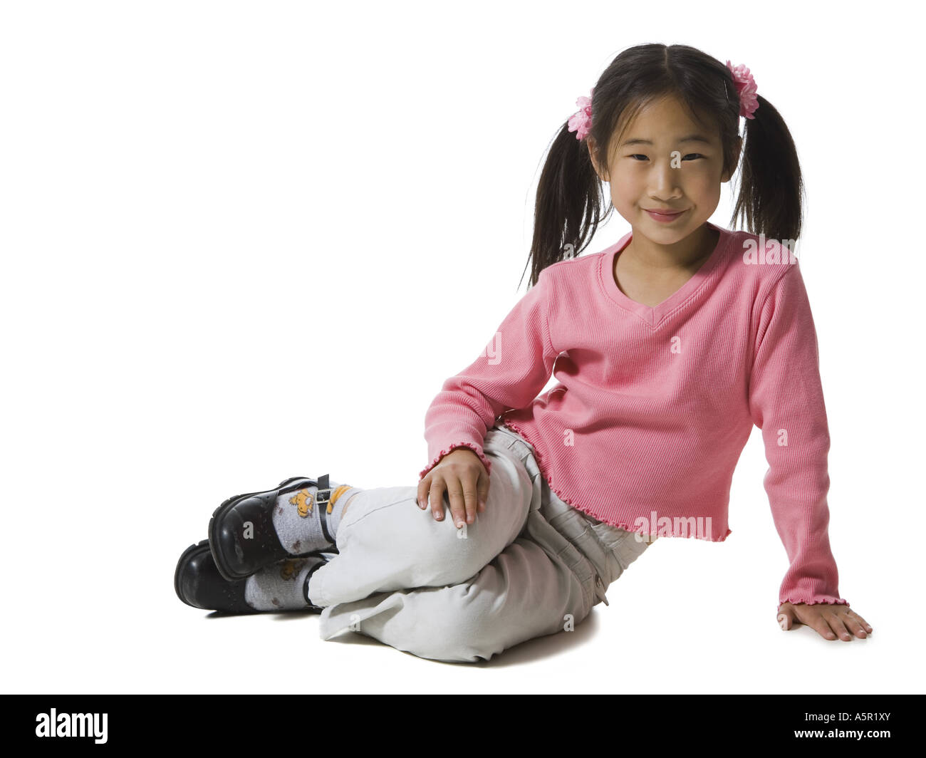 Portrait of a girl sitting on the floor and smiling Stock Photo