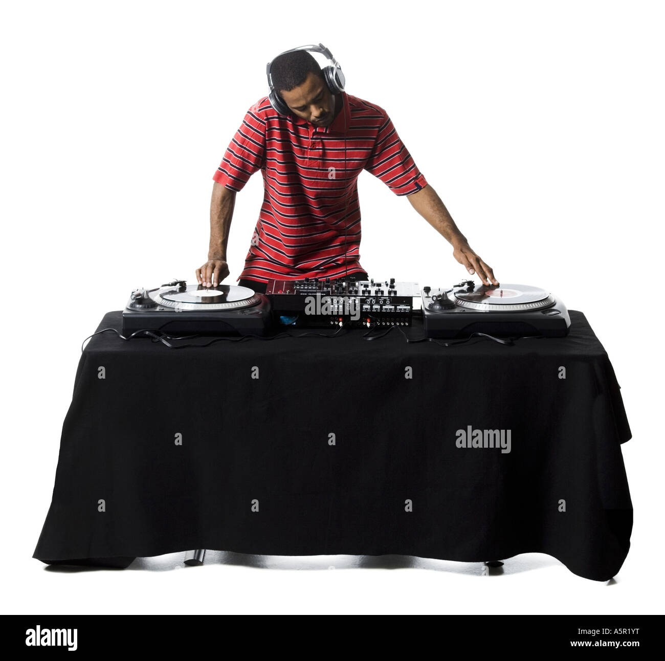 DJ with headphones spinning records Stock Photo