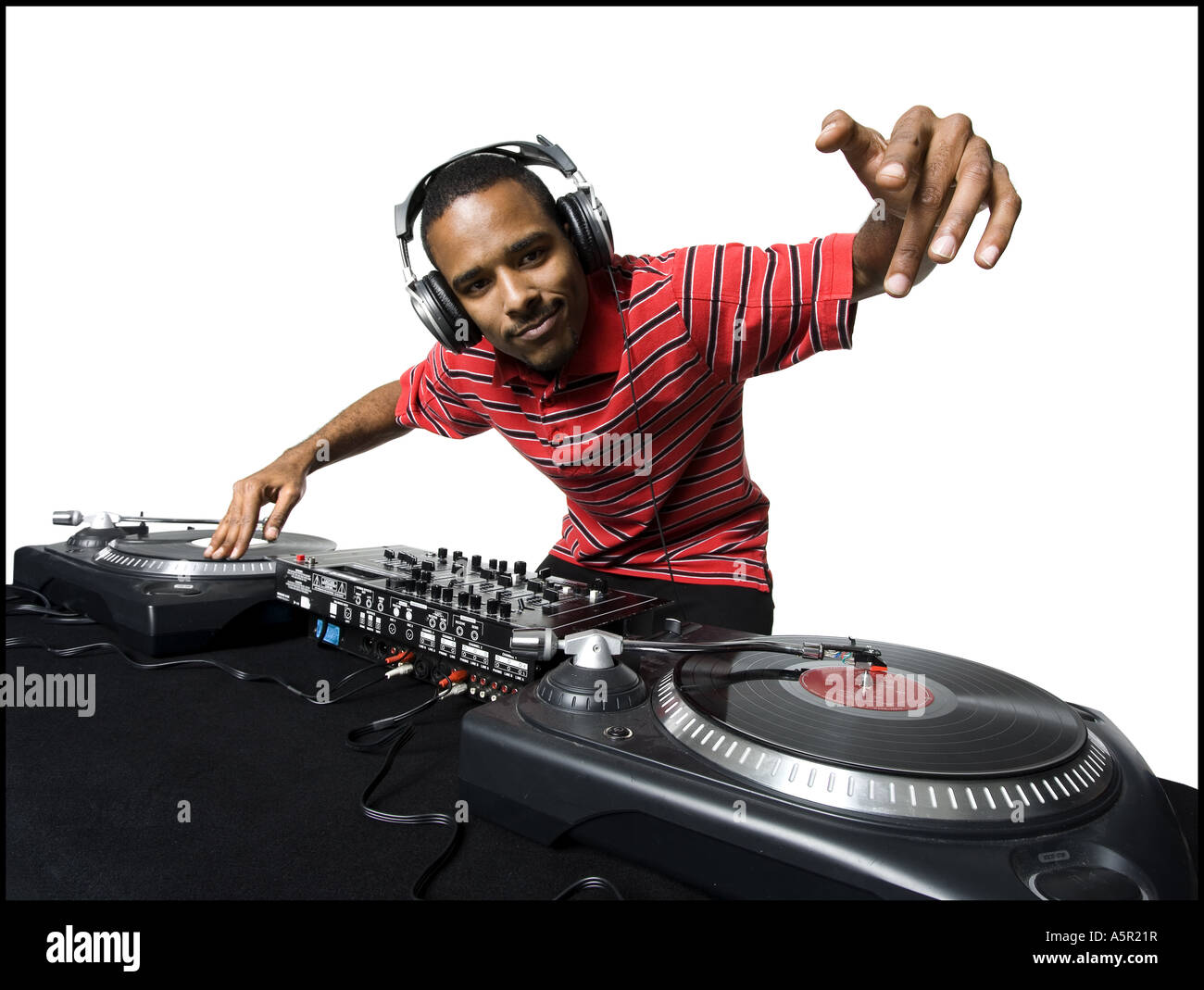 DJ with headphones spinning records Stock Photo - Alamy
