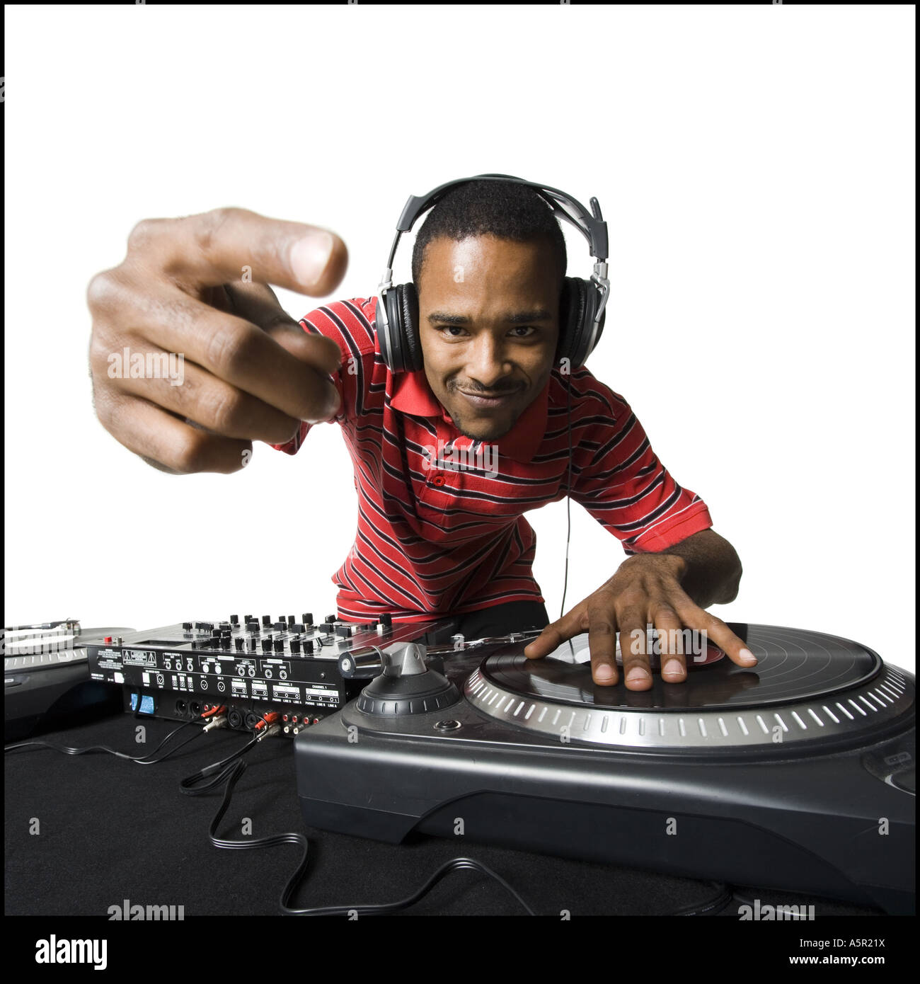 DJ with headphones spinning records Stock Photo - Alamy