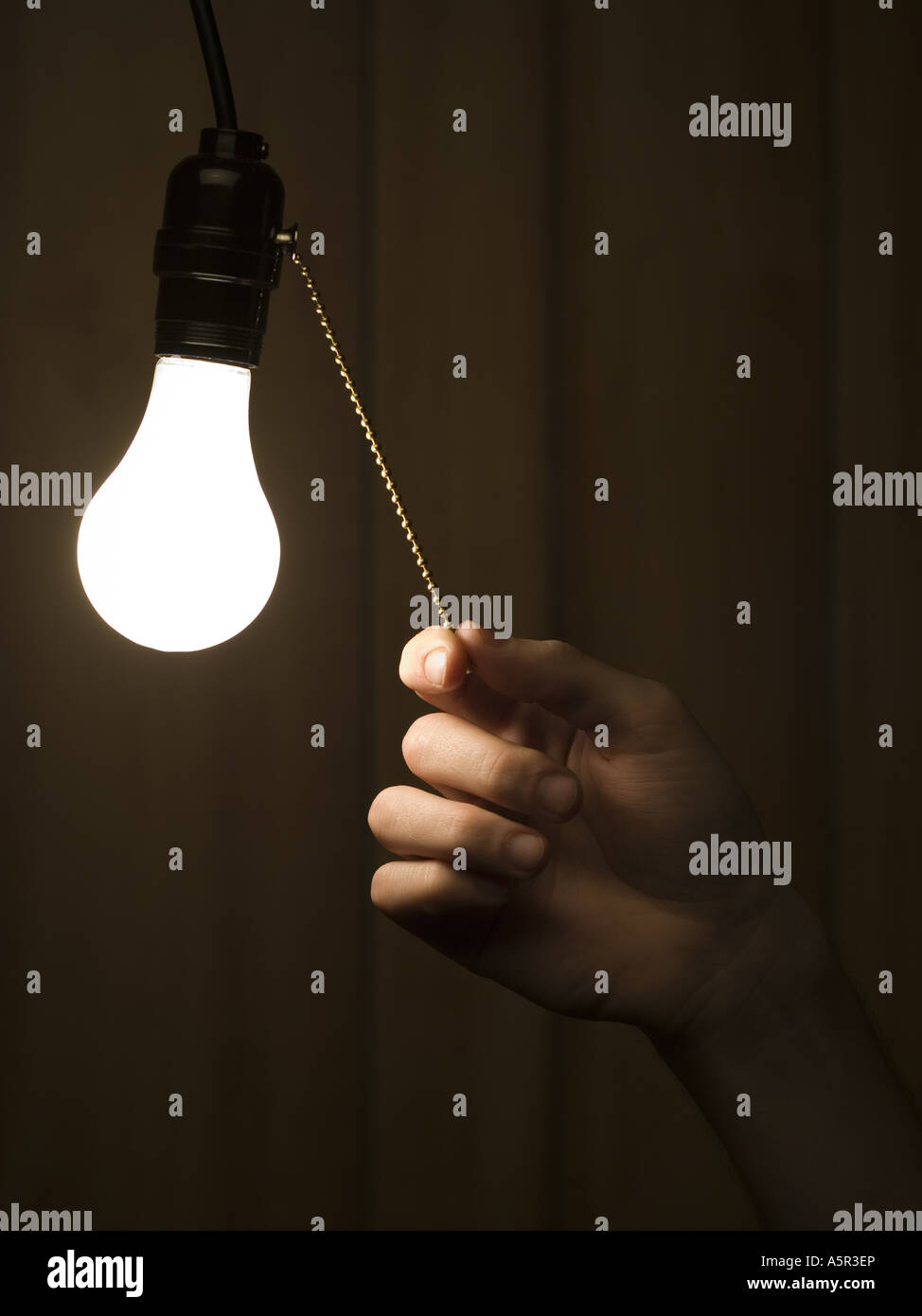 Man pulling light switch Stock Photo Alamy