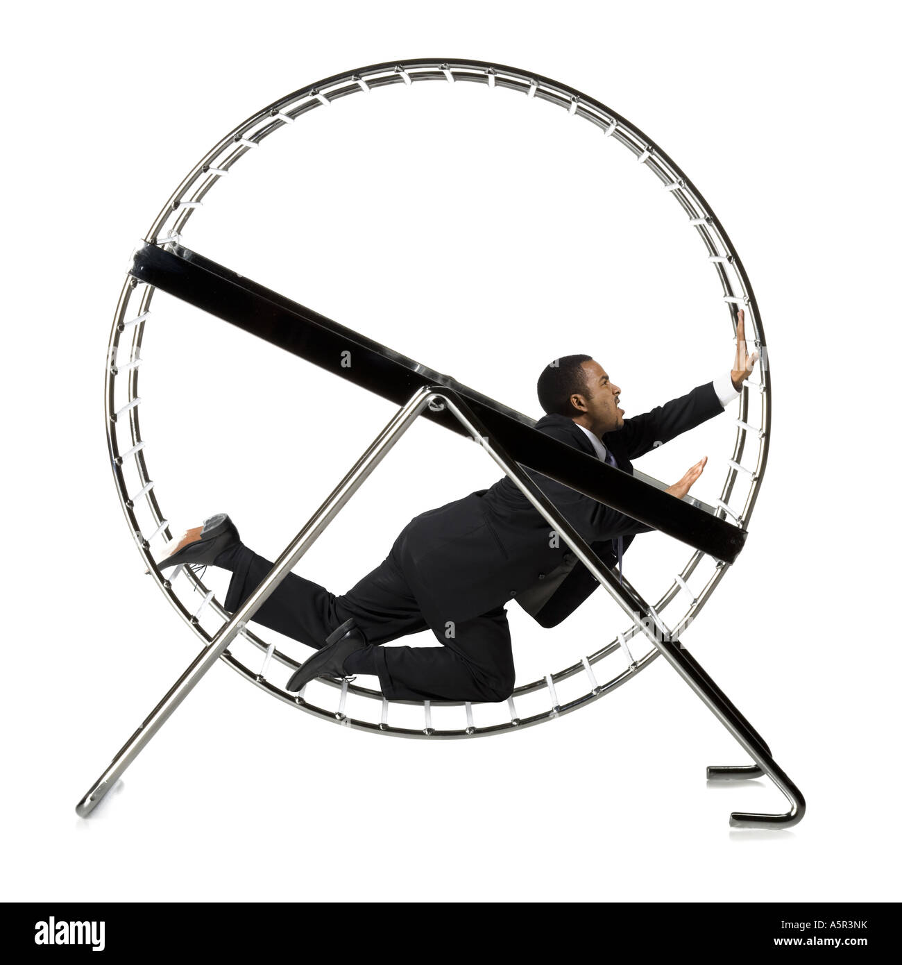 Businessman crawling in rodent wheel Stock Photo