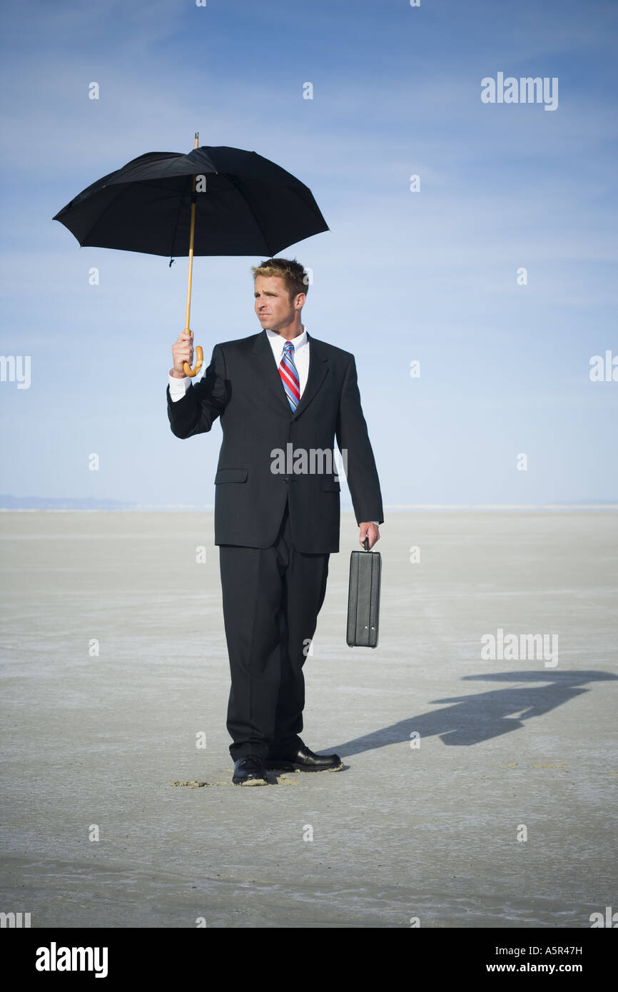 Portrait of a businessman holding an umbrella Stock Photo - Alamy