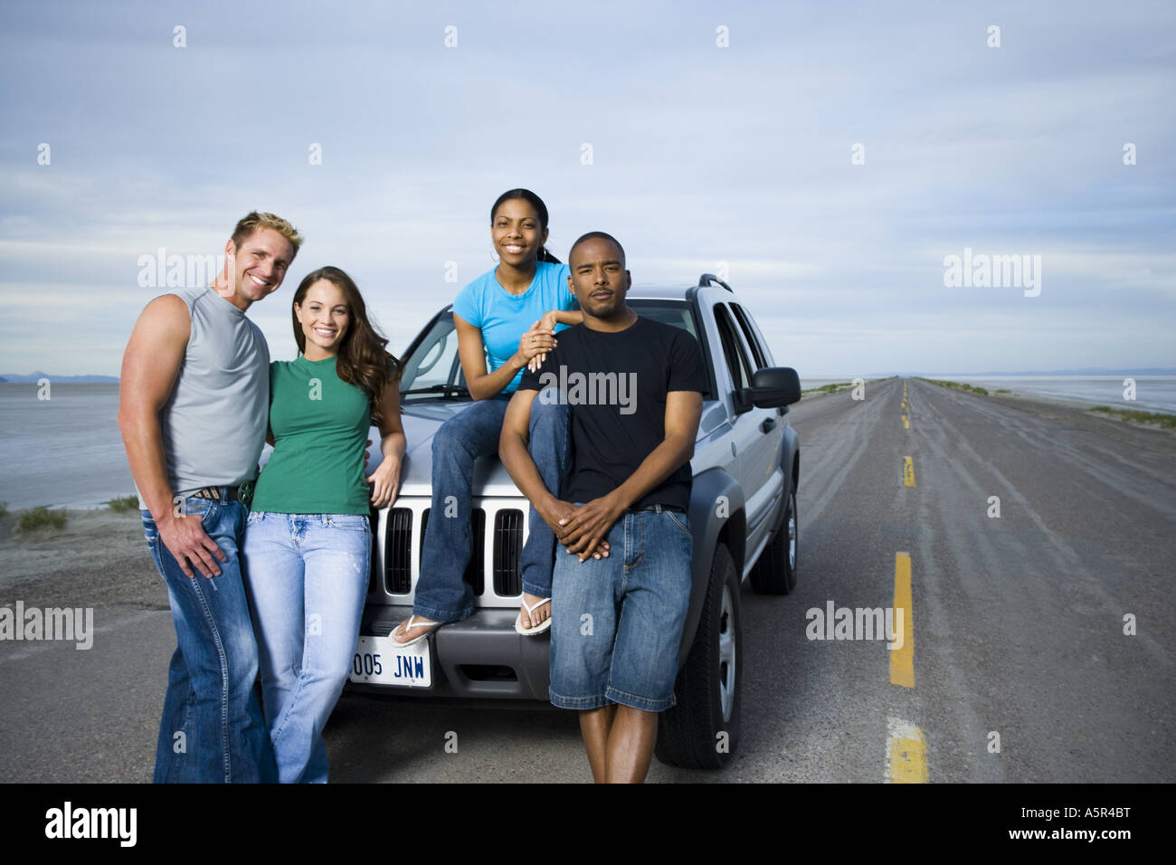 Portrait of a mid adult man and a young man smiling with two young ...
