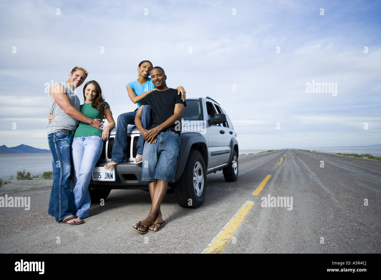Portrait of a mid adult man and a young man smiling with two young ...