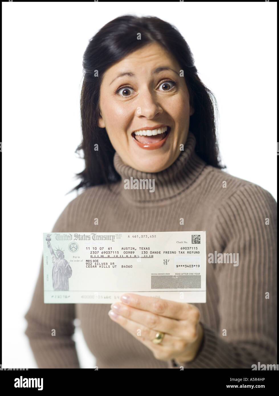 Woman holding cheque from US Treasury Stock Photo - Alamy