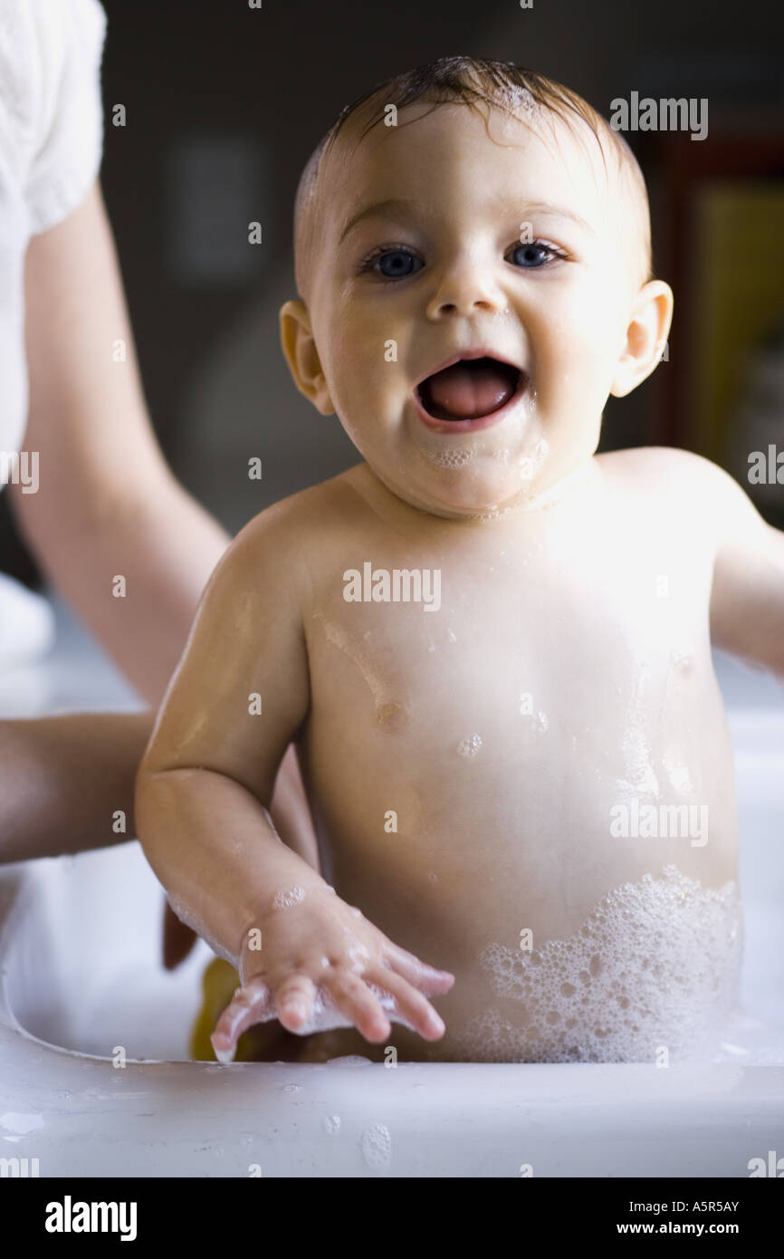 Woman bathing baby in sink Stock Photo Alamy