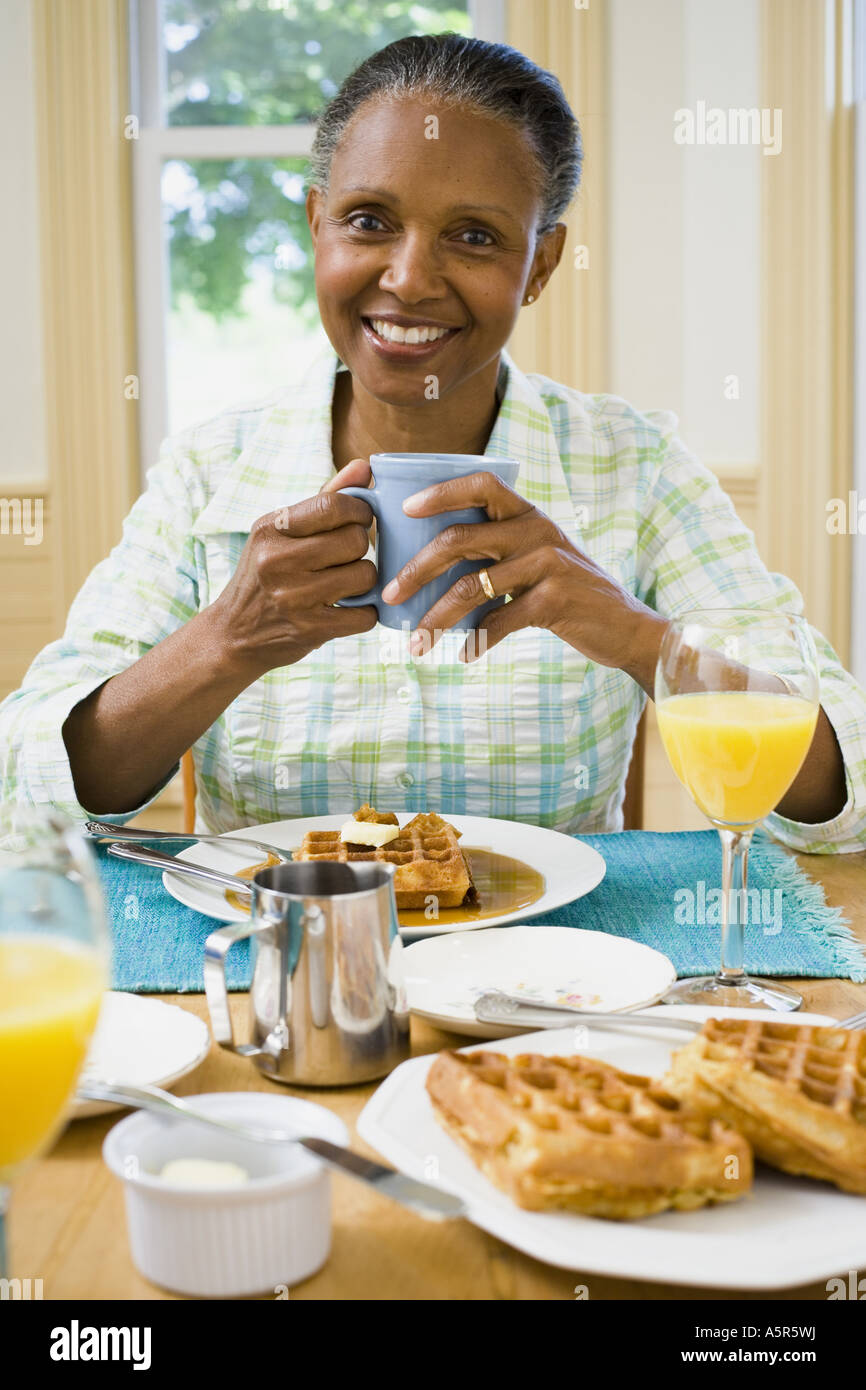 Portrait of a senior woman having breakfast Stock Photo - Alamy