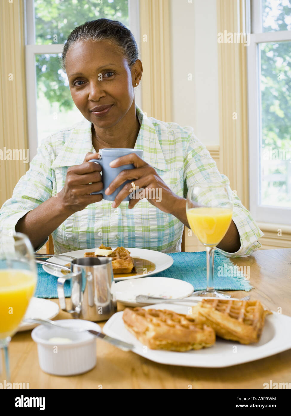 Portrait of a senior woman having breakfast Stock Photo - Alamy