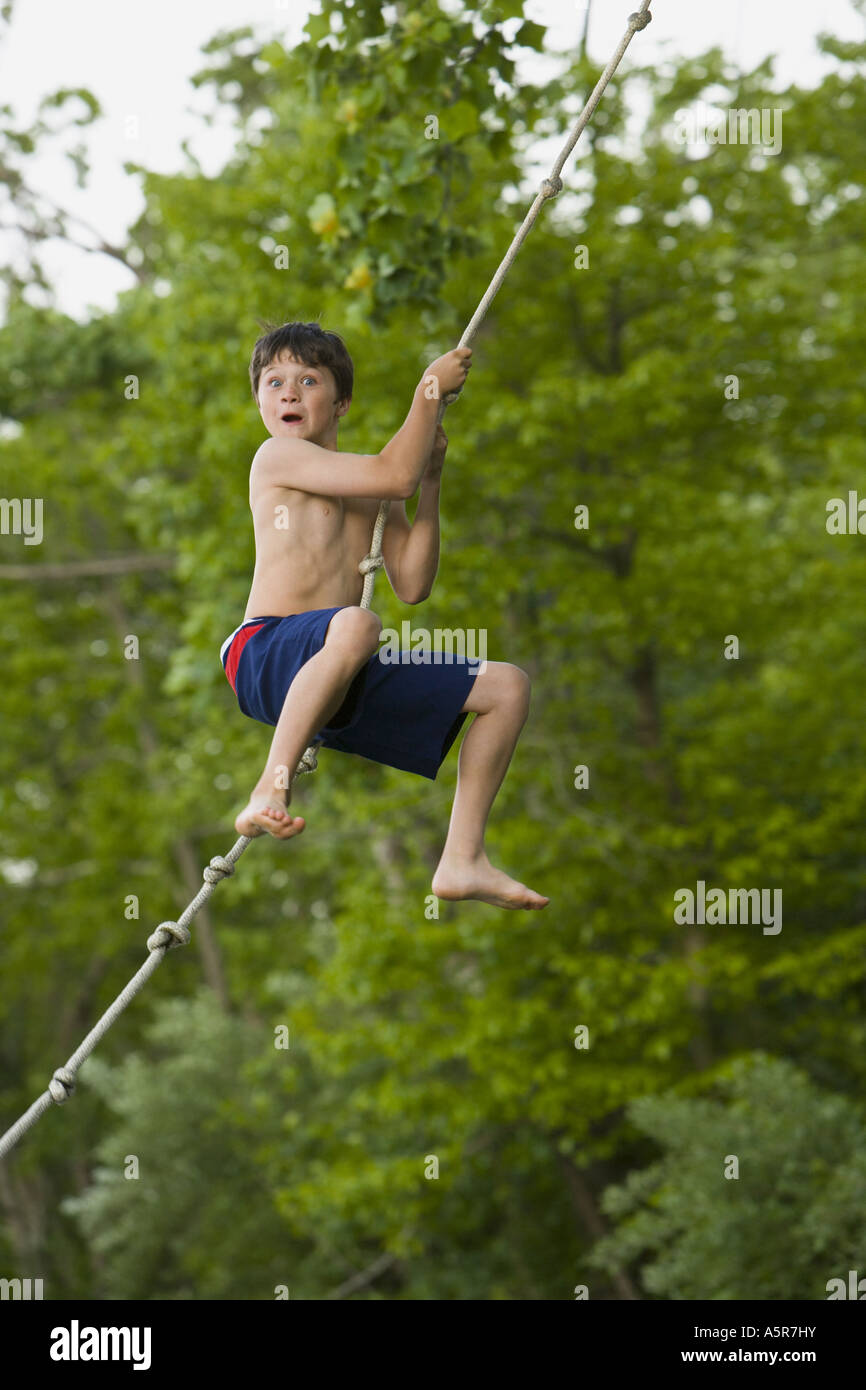 Boy Using A Rope Profile of a boy swinging on a rope hi-res stock photography and images ...