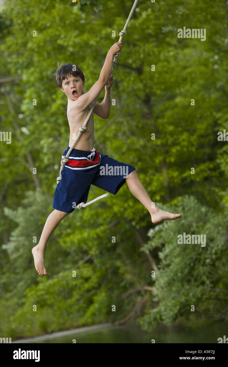 Boy Using A Rope Profile of a boy swinging on a rope hi-res stock photography and images ...