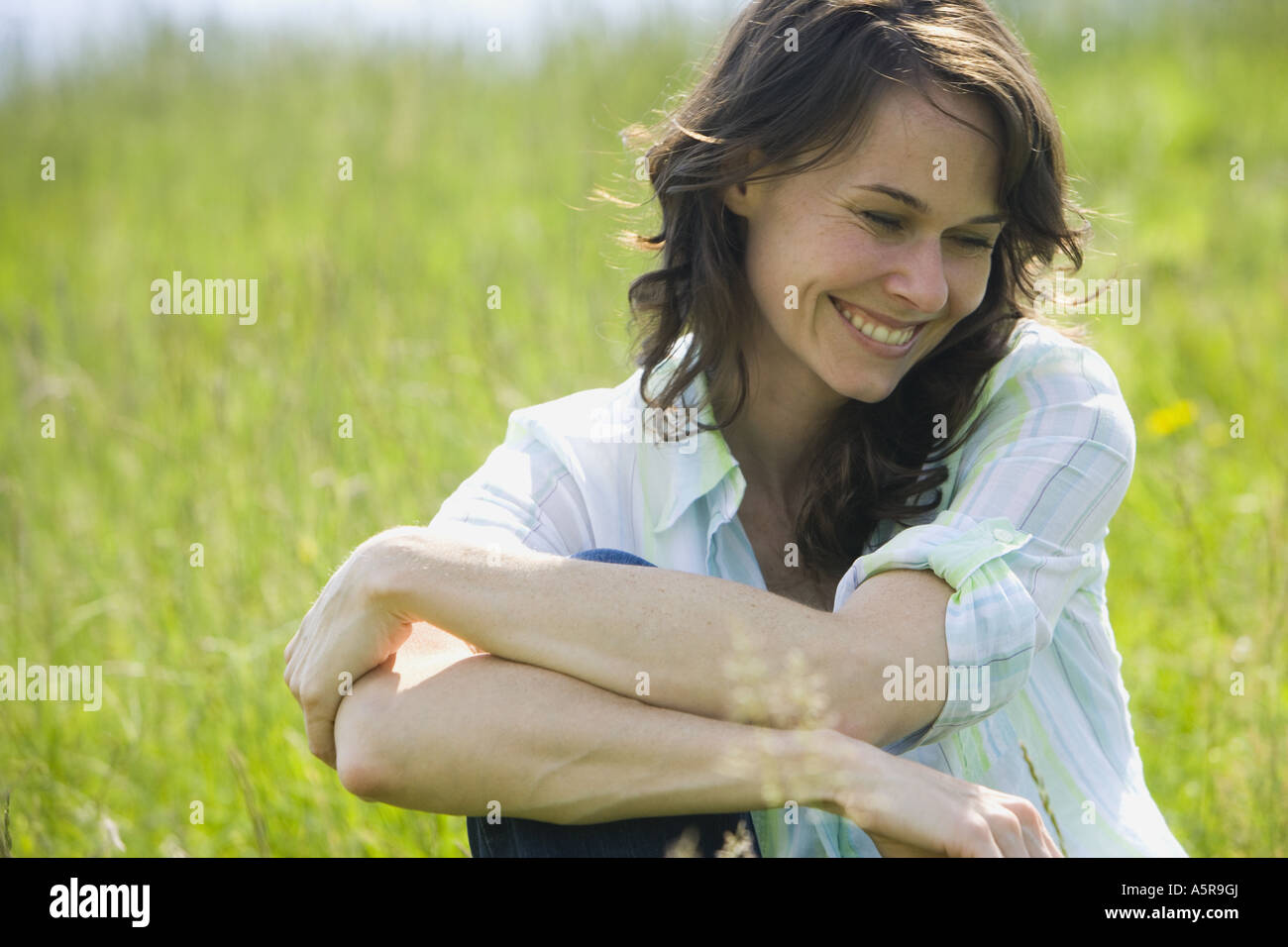 Close up of a woman smiling with her arms crossed Stock Photo - Alamy