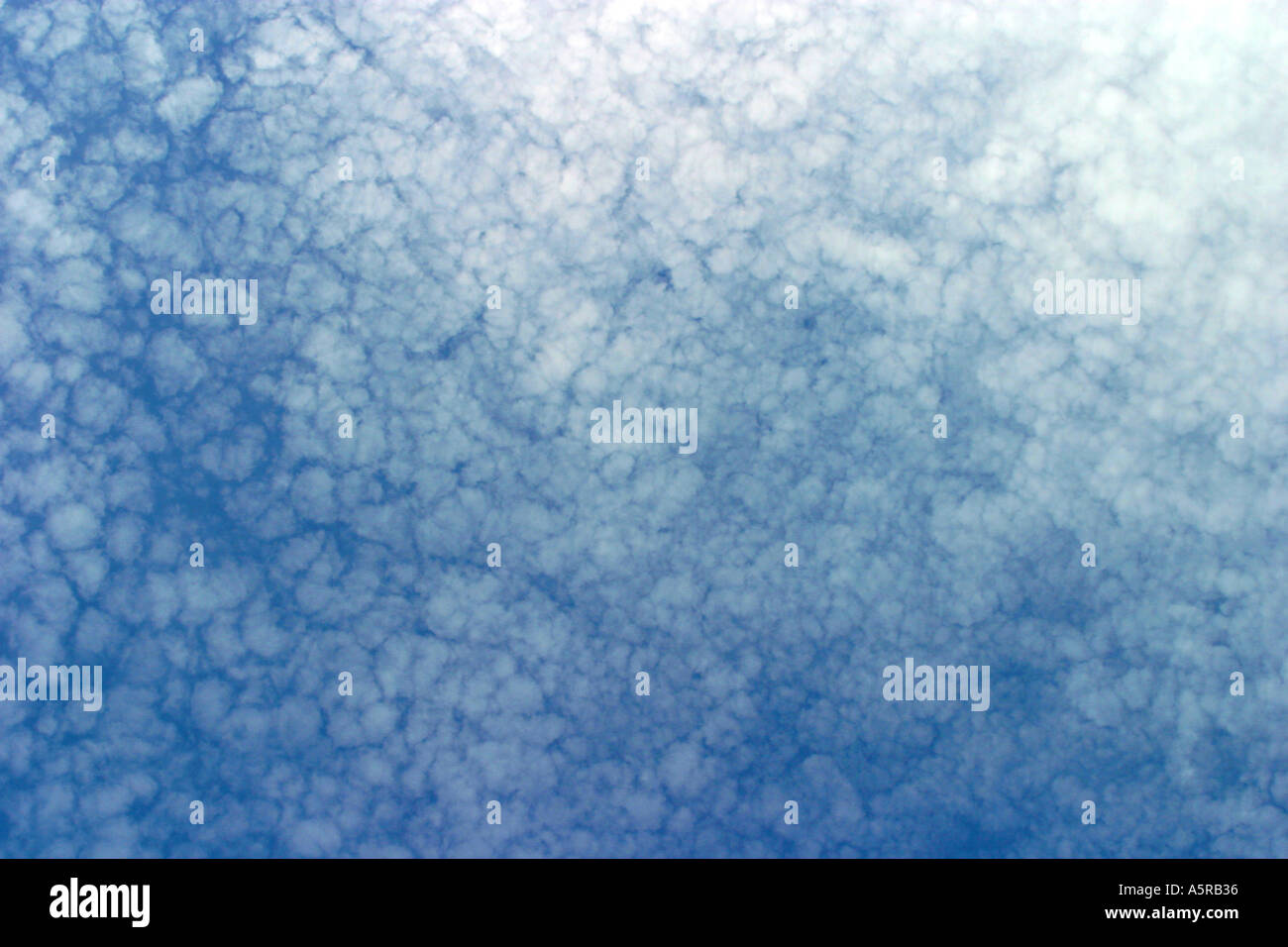 Blue sky with high level broken cloud Stock Photo - Alamy