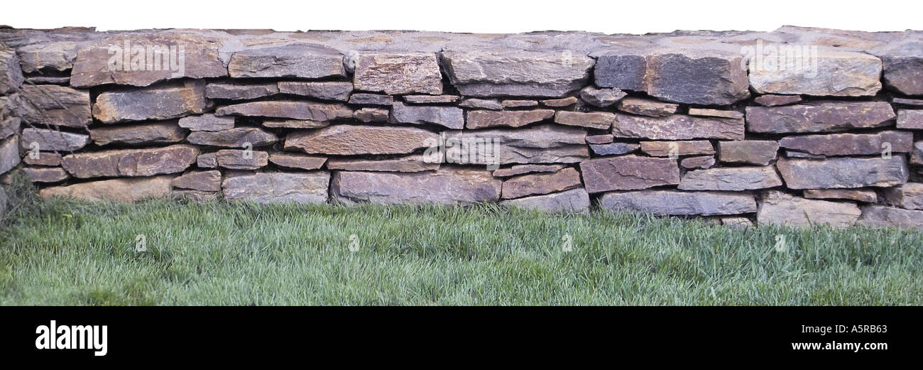 Stone rock wall landscaping fence Stock Photo - Alamy