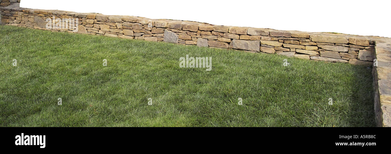 Stone rock wall landscaping fence Stock Photo - Alamy