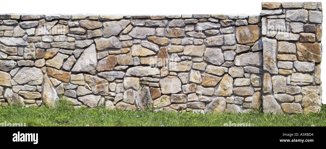 Stone rock wall landscaping fence Stock Photo - Alamy