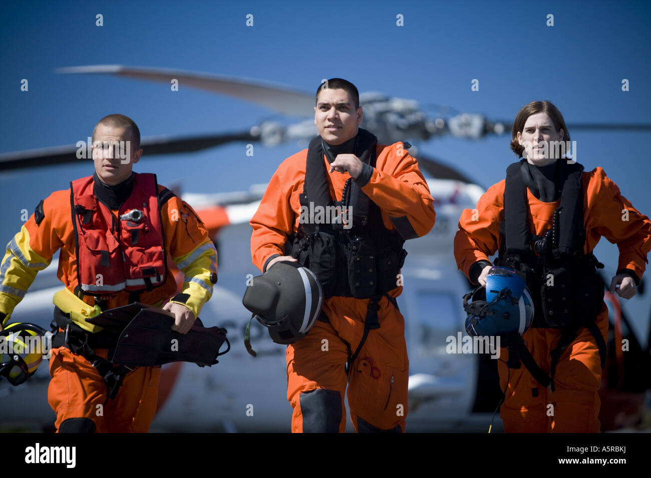 Coast guard workers in uniforms with helicopter Stock Photo Alamy