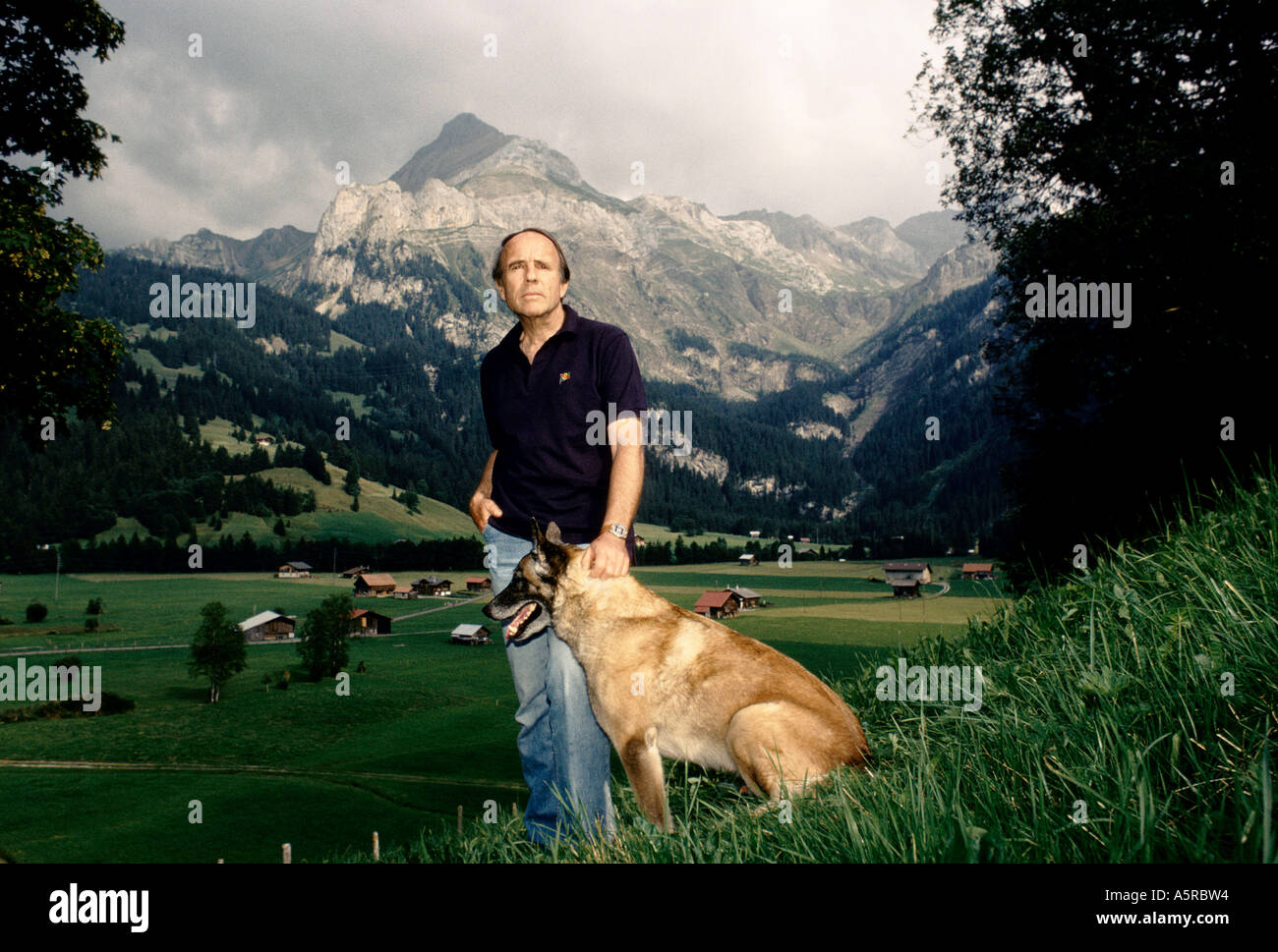 Prince Sadruddin Aga Khan his pet dog in the Alps UN High Commissioner active in human rights environmental protection movements Stock Photo