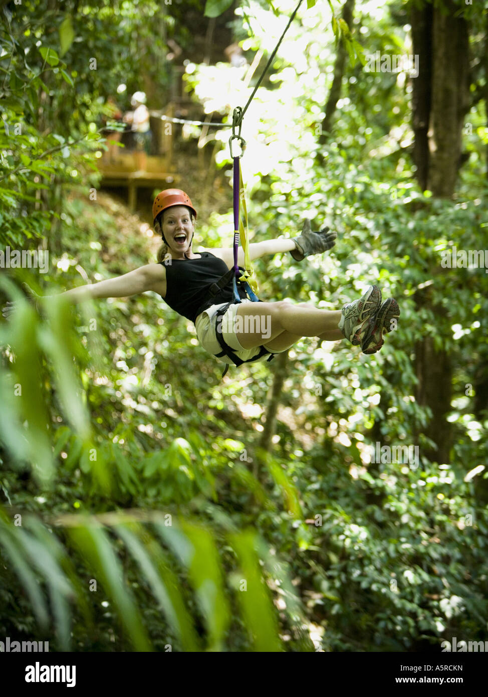 Portrait of a young woman sliding on a rope Stock Photo Alamy