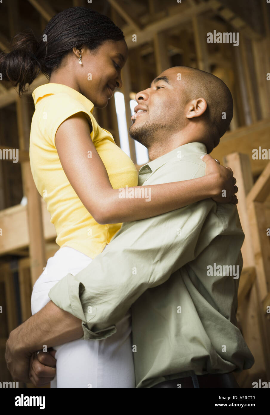 Profile of a young man embracing a young woman and smiling Stock Photo ...