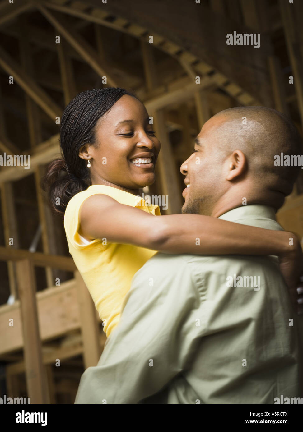 Profile of a young man embracing a young woman and smiling Stock Photo ...