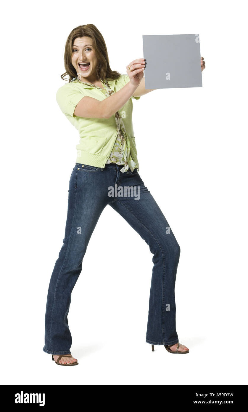 Portrait of a young woman standing and holding a blank sign Stock Photo ...