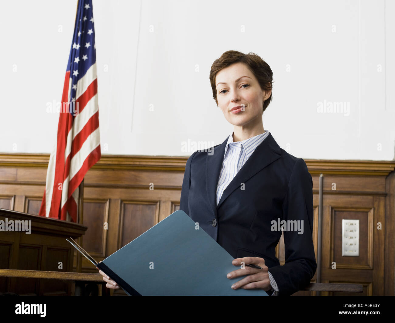Portrait of a female lawyer standing in a courtroom and smiling Stock Photo