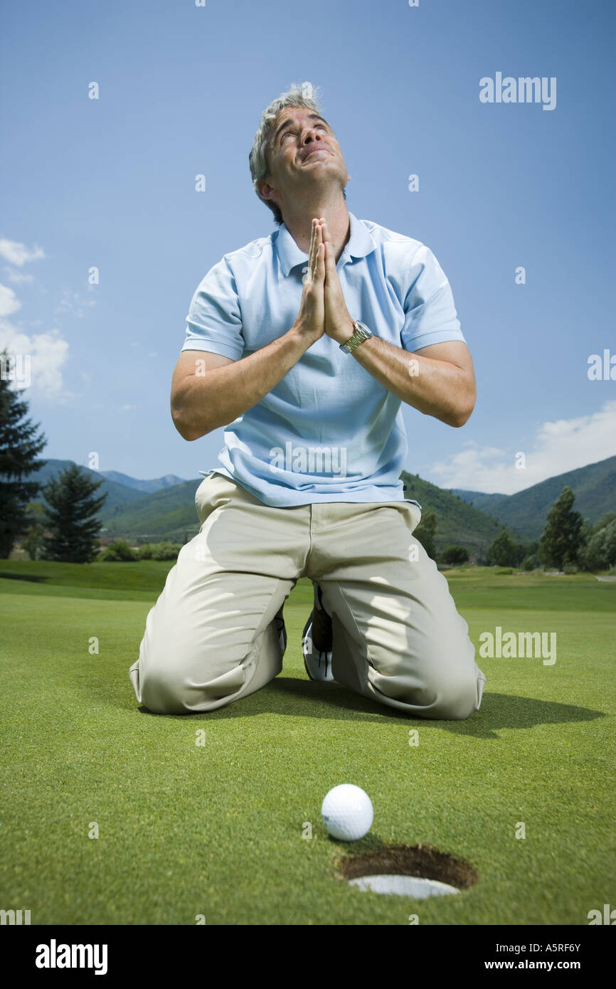 One caucasian man kneeling praying hi-res stock photography and images ...
