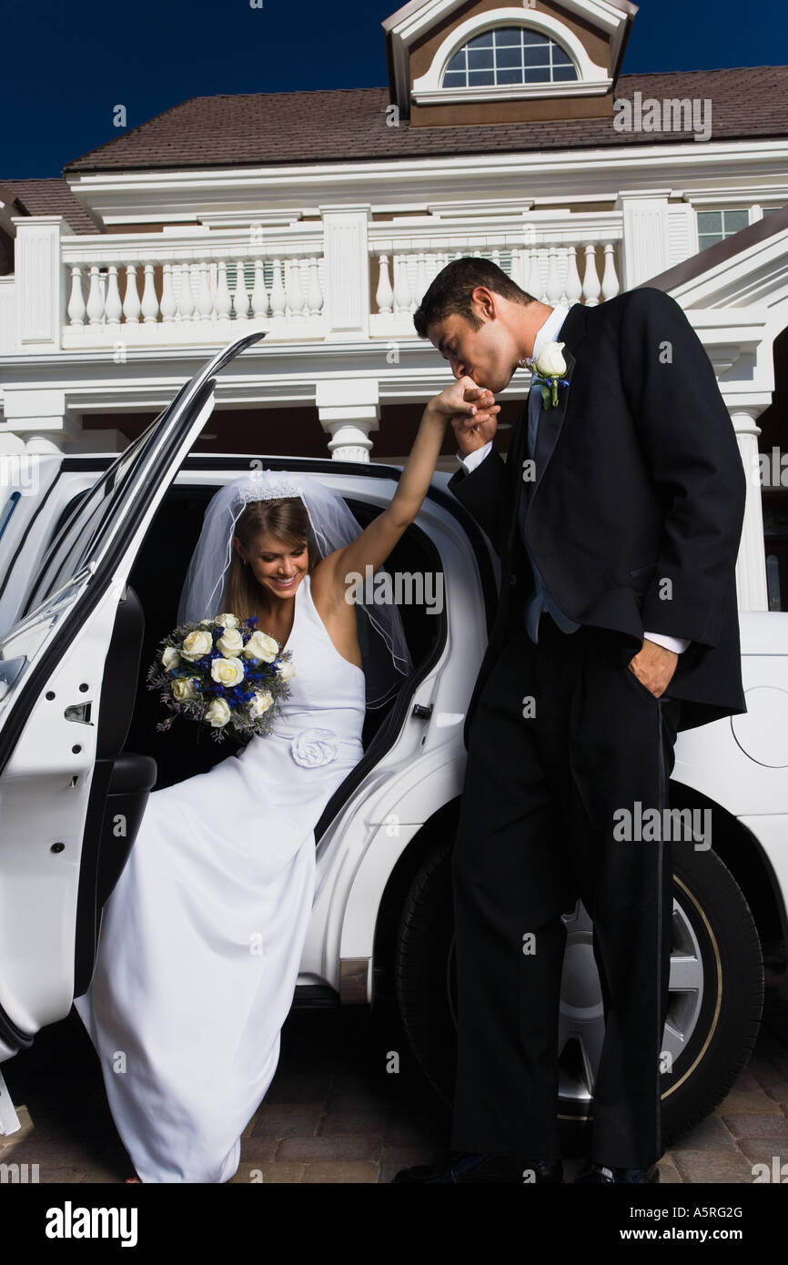 Groom kissing his bride s hand and getting out of a car Stock Photo - Alamy