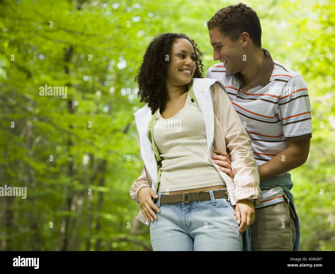 Close up of a young man embracing a young woman from behind Stock Photo ...