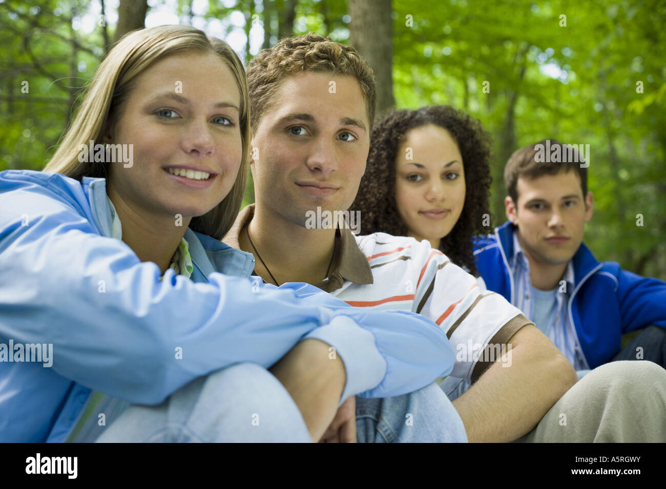 Portrait of two young women and two young men sitting and smiling Stock ...