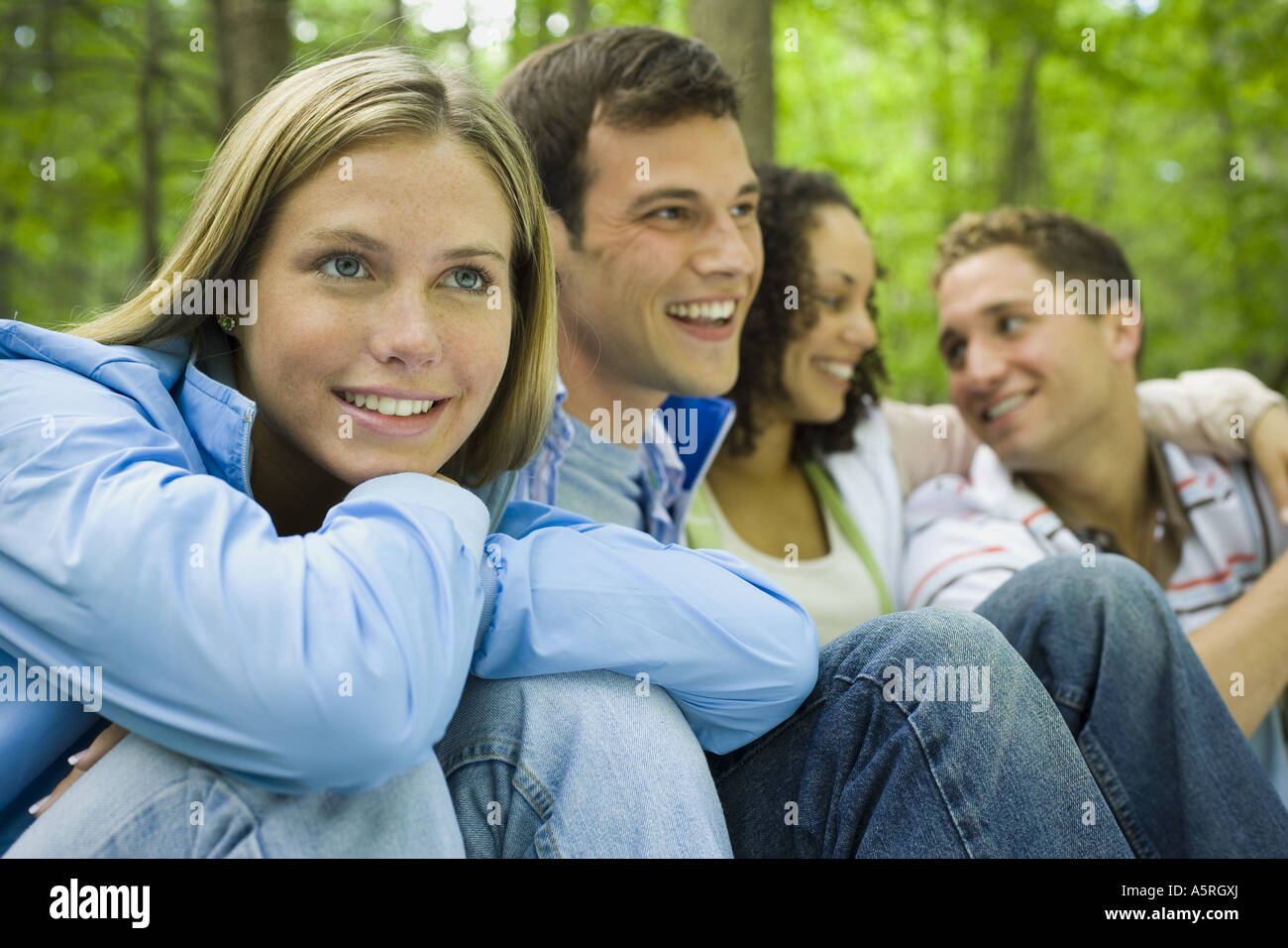 Close up of two young women and two young men sitting and smiling Stock ...