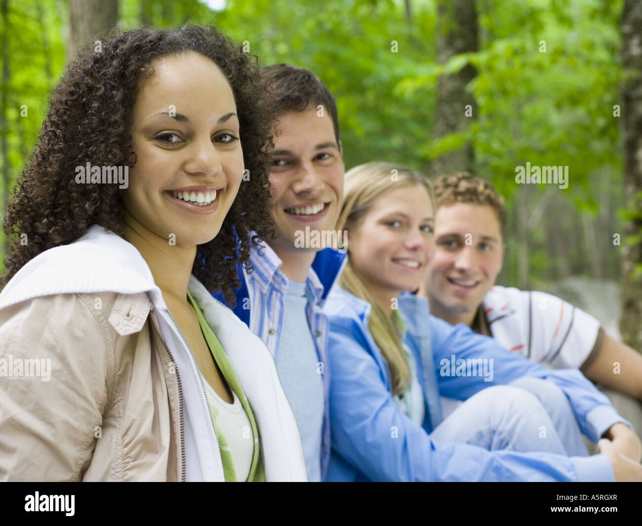 Portrait of two young women and two young men smiling Stock Photo - Alamy