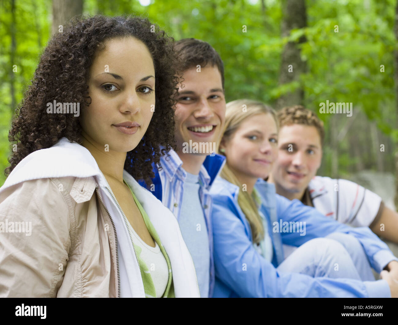 Portrait of two young women and two young men smiling Stock Photo - Alamy