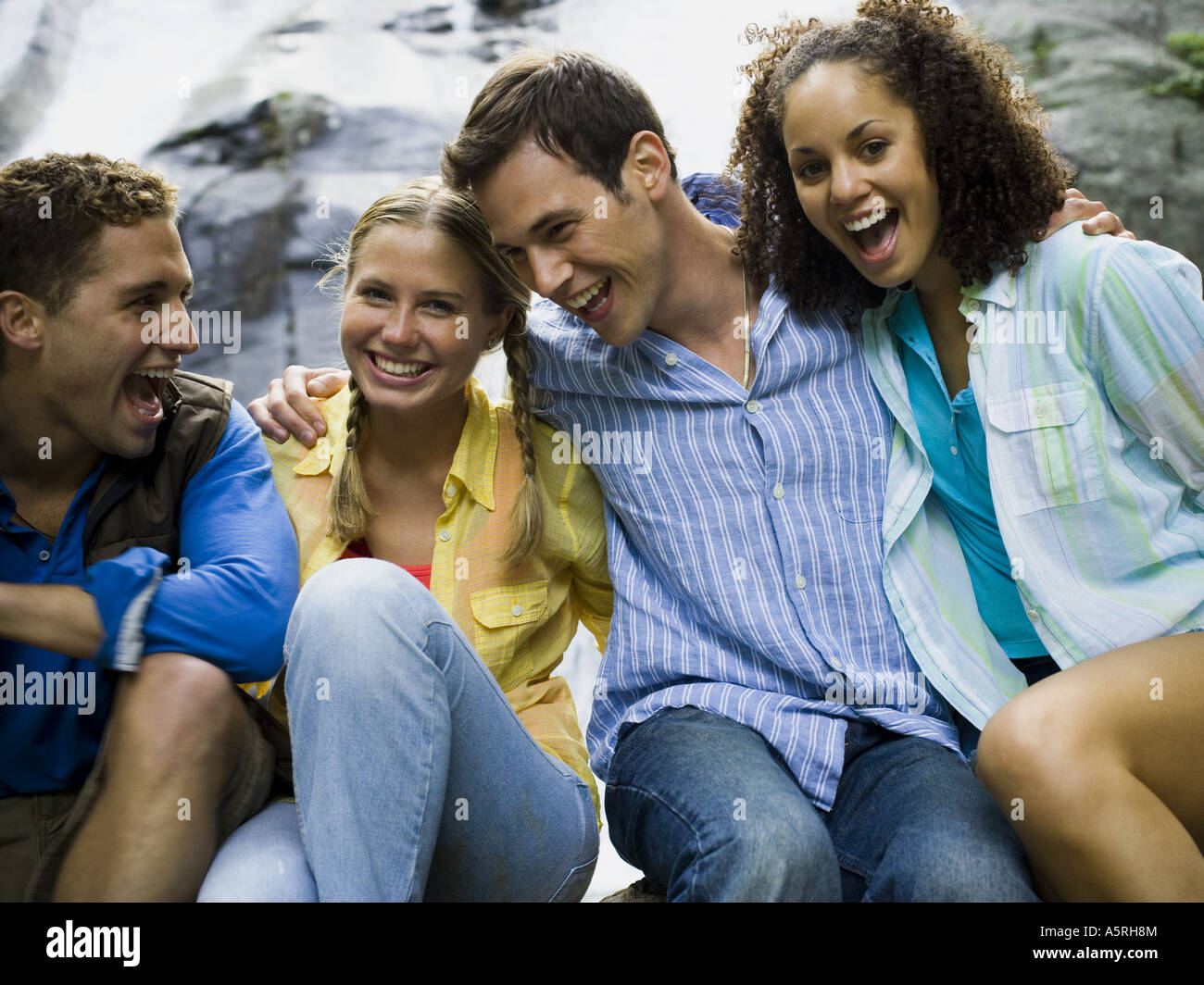 Close up of two young women and two young men smiling Stock Photo - Alamy