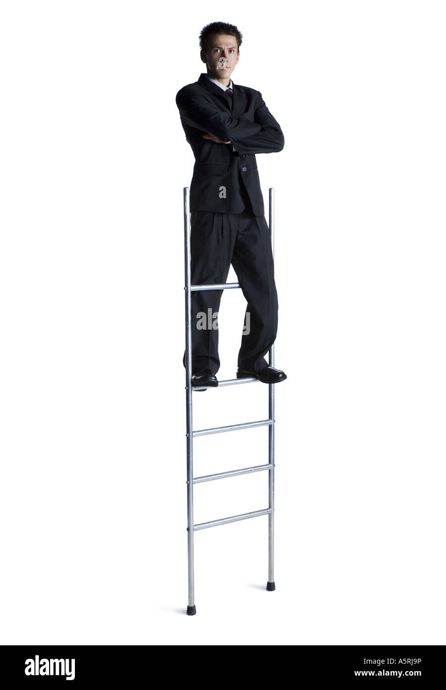 Businessman standing on corporate ladder Stock Photo - Alamy