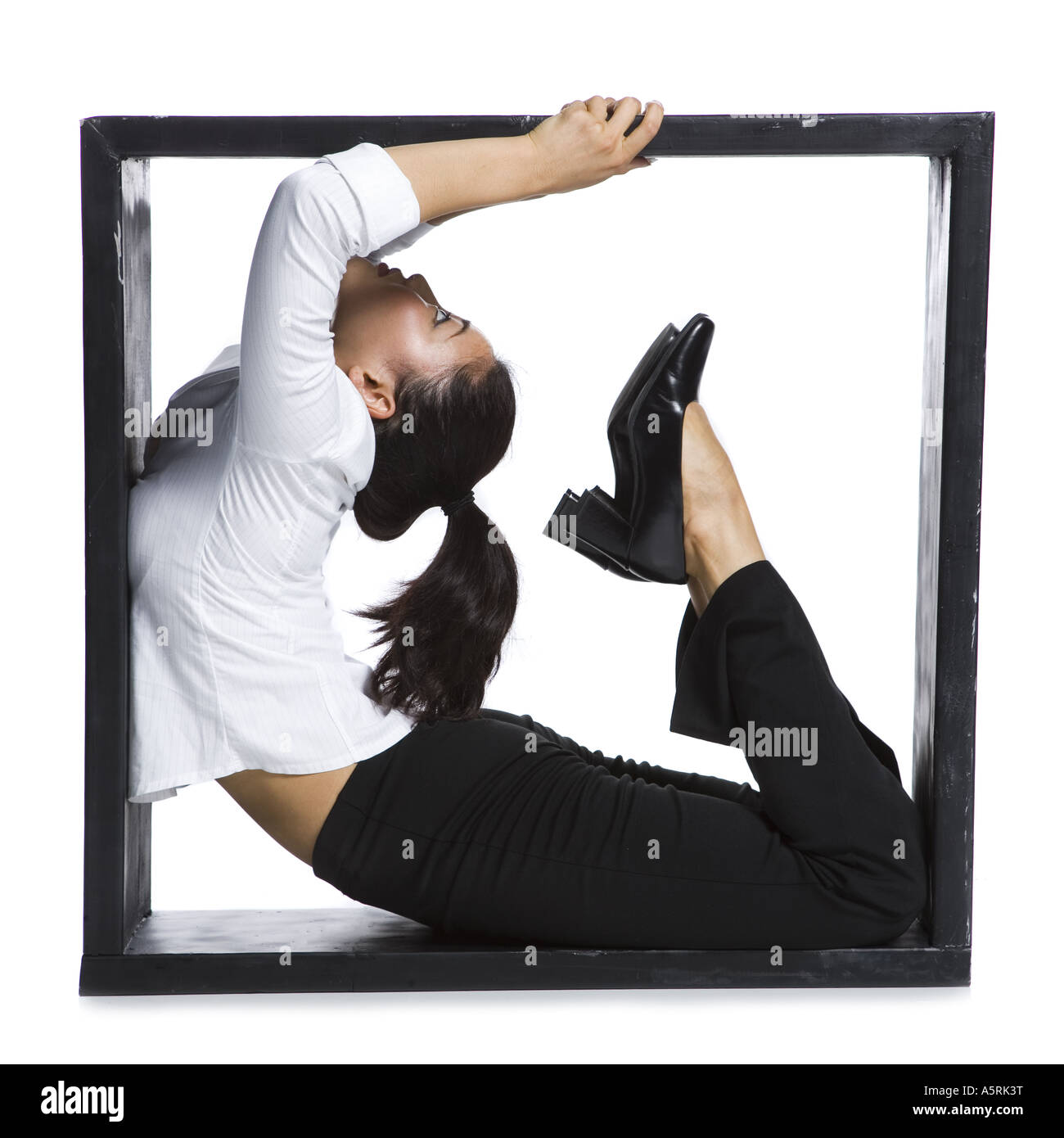 Female contortionist businesswoman inside the box Stock Photo