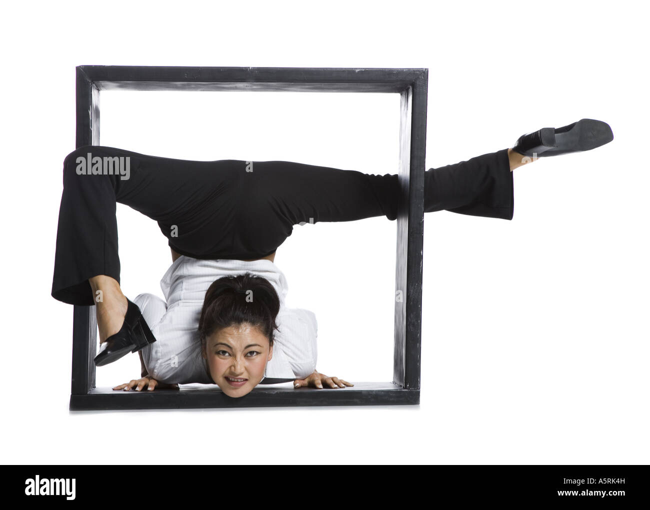 Female contortionist businesswoman inside the box Stock Photo