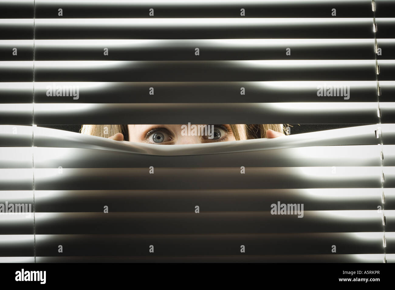 Peeping through blinds hi-res stock photography and images - Alamy