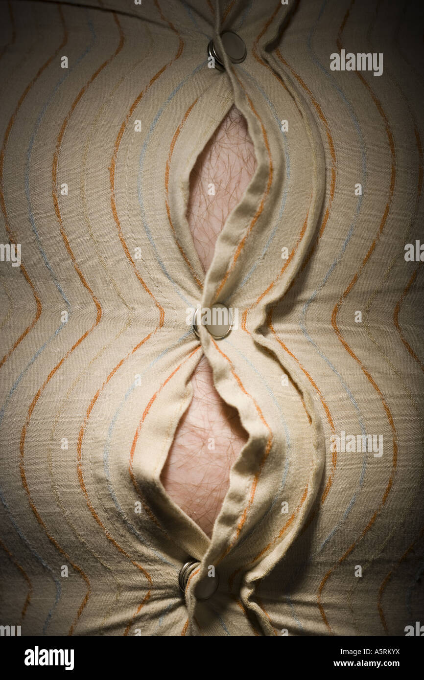Close up of fat stomach bursting through shirt Stock Photo