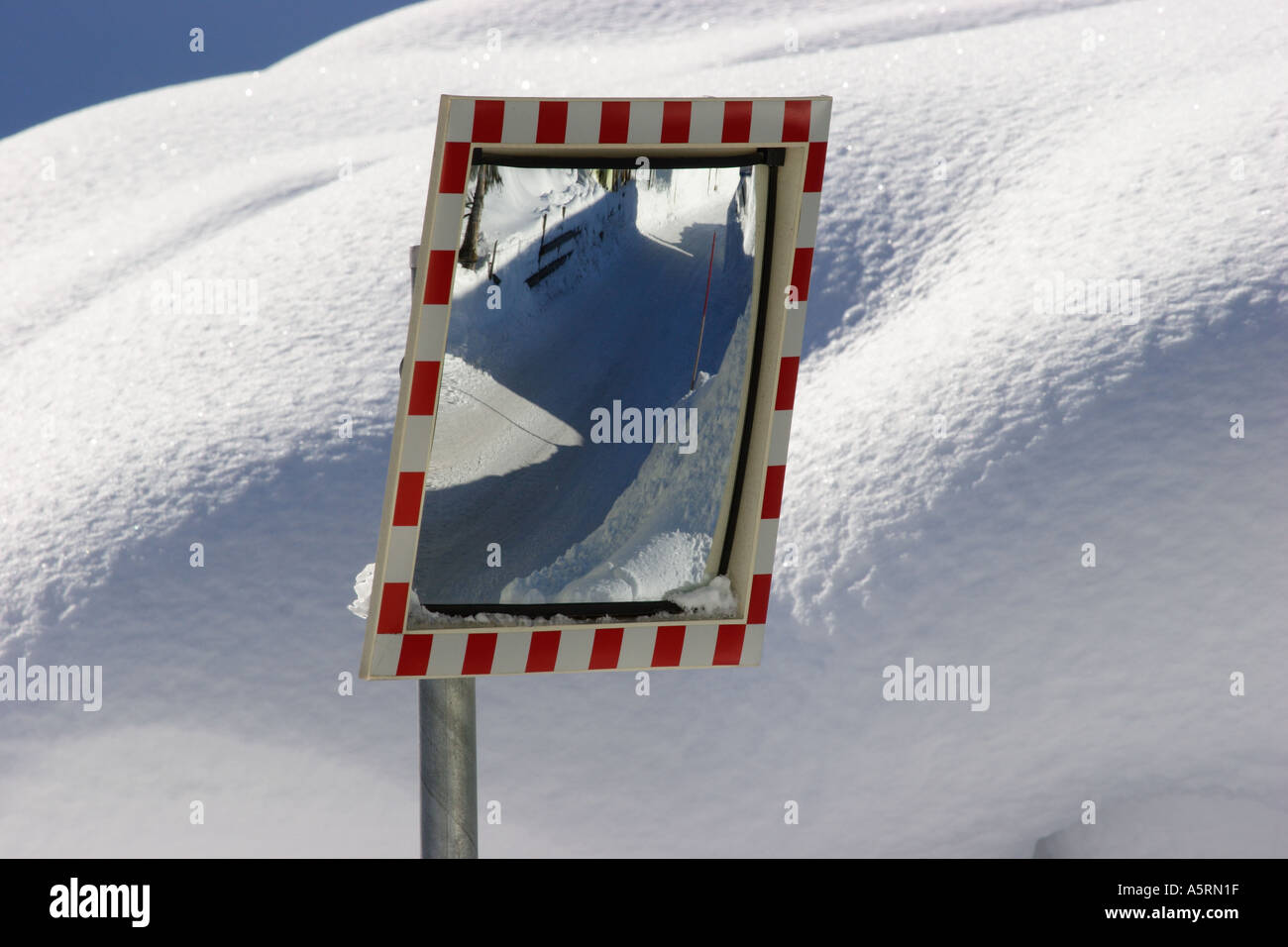 a road is reflected in a traffic mirror Styria Austria Stock Photo