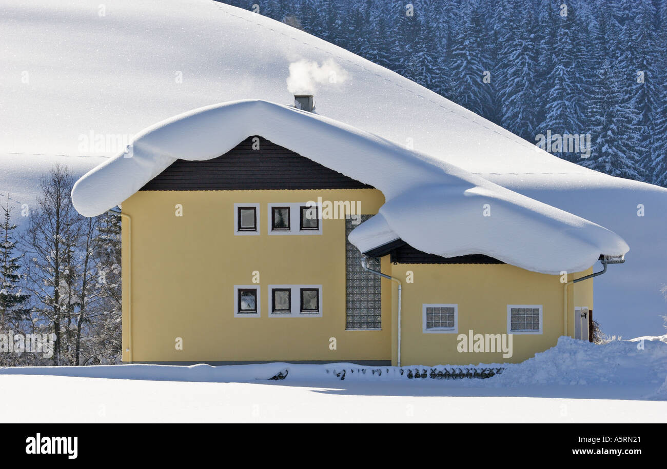 a house in Krungl is covered with snow Styria Austria Stock Photo