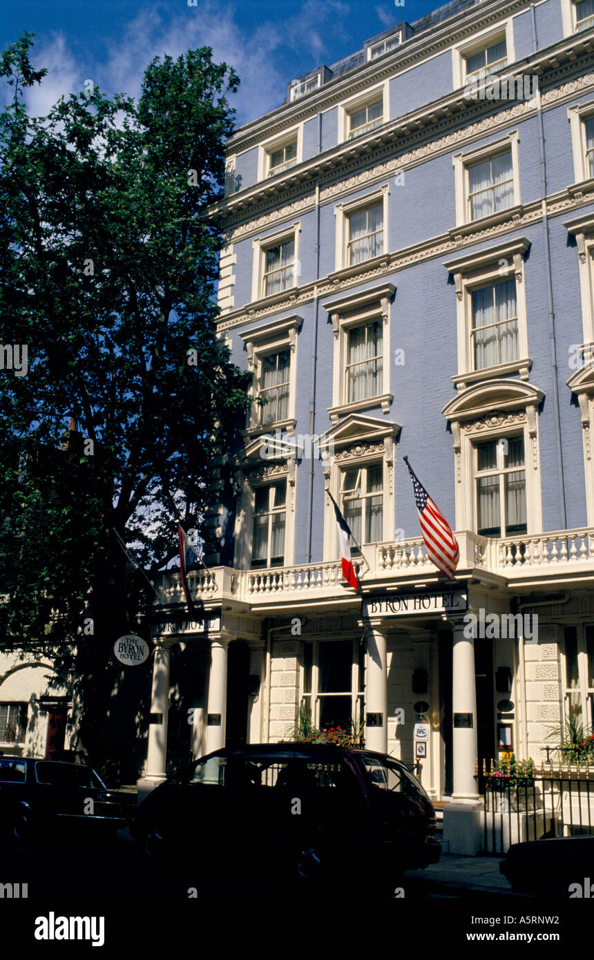 BYRON HOTEL QUEENSWAY LONDON HOTEL SIGN ON TREE FRENCH AMERICAN FLAGS OUTSIDE HOTEL JUNE 1994 Stock Photo