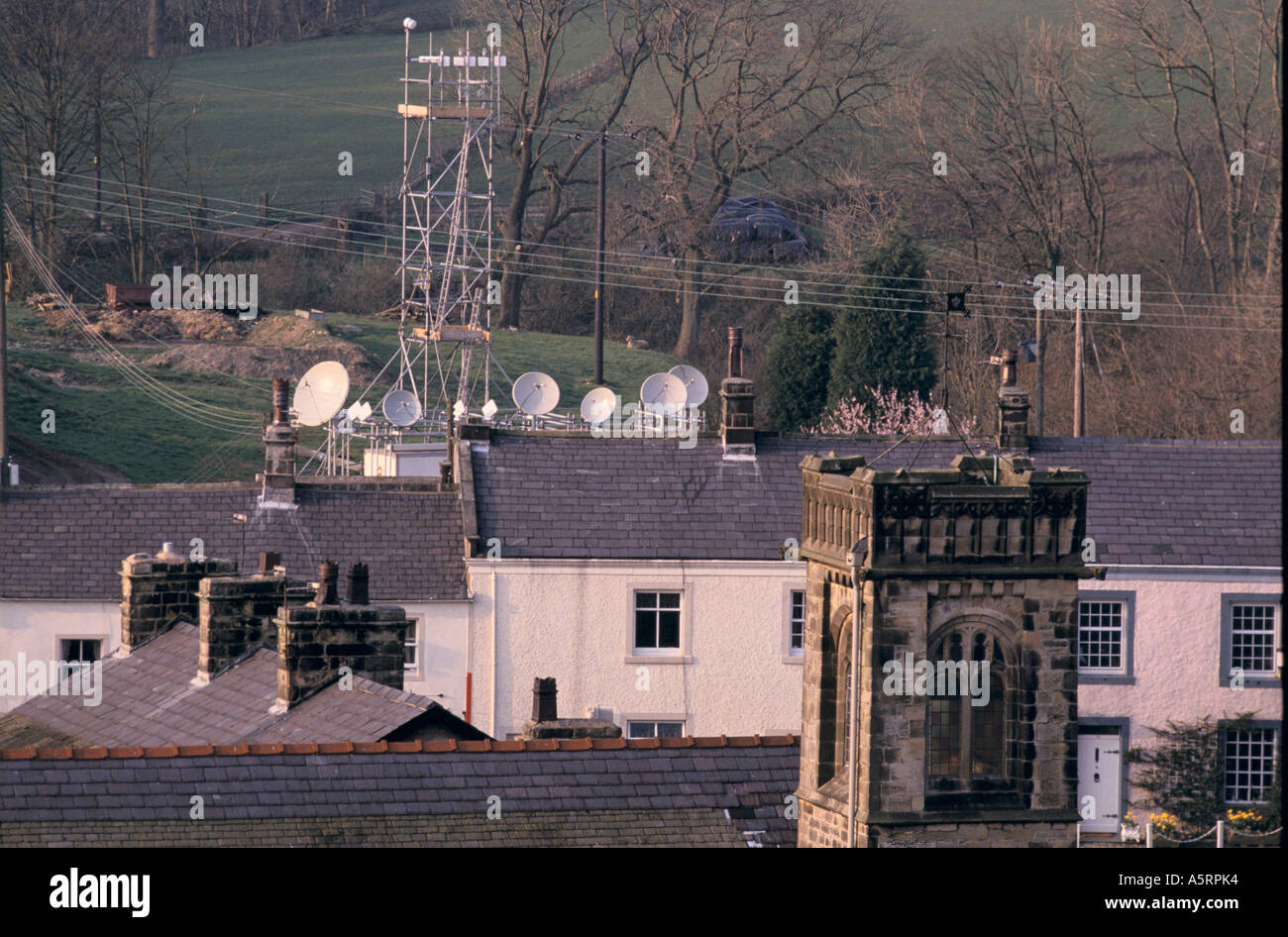 SATELLITE DISHES PROTRUDE OVER ROOFTOPS IN WADDINGTON LANCASHIRE Stock