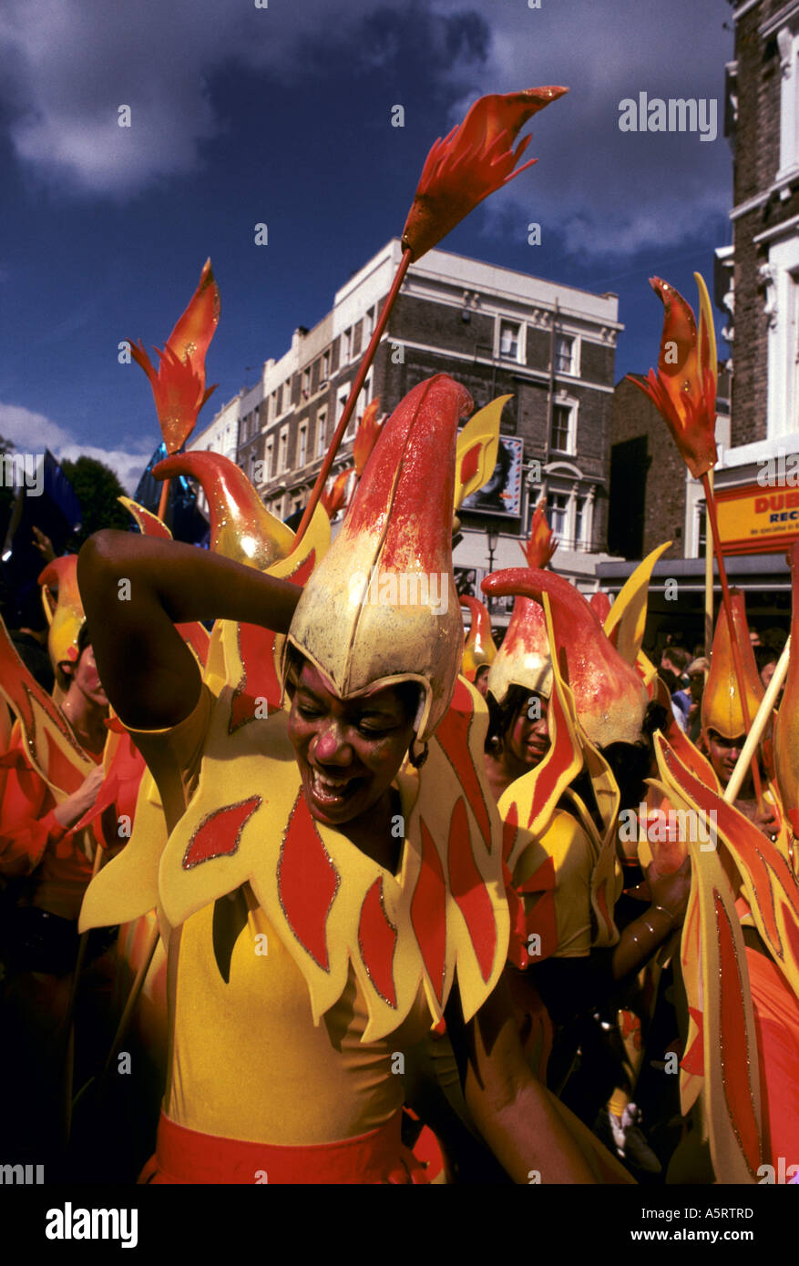 NOTTING HILL CARNIVAL LONDON GIRLS FROM ONE OF THE COMPETING TEAMS DRESSED IN COSTUMES WITH A THEME OF FLAMES FIRE Stock Photo